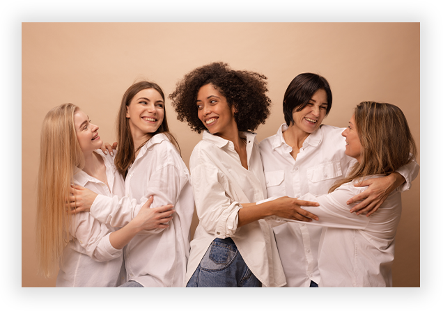 portrait-multiethnic-adults-young-women-white-shirts-hugging-each-other-brown-background